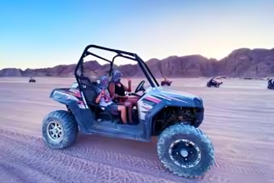 Couple driving a double-seater desert buggy in Sharm El Sheikh.