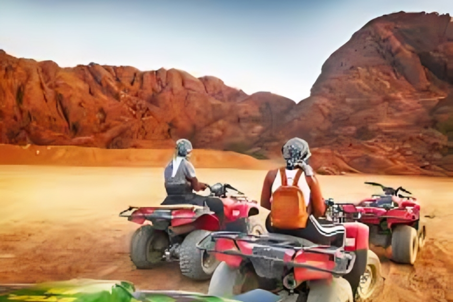quad bikes riding through Sharm El Sheikh desert at sunrise.